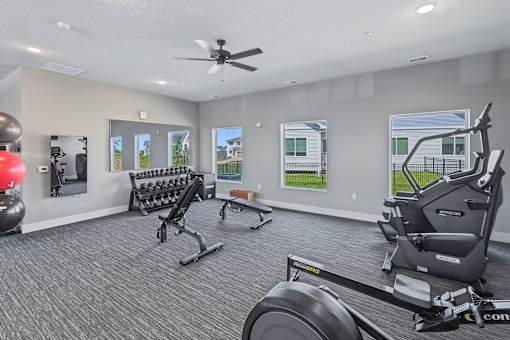 A spacious home gym with a variety of exercise equipment.