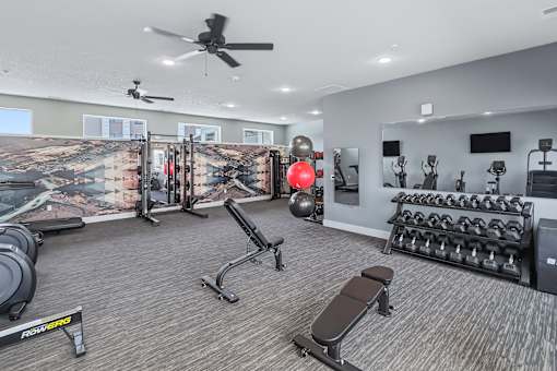 A well-equipped gym with a variety of exercise equipment.