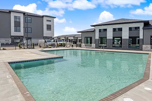 A swimming pool in front of a building.