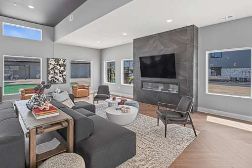 A modern living room with a grey couch and a television.