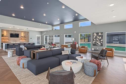 A modern living room with a grey sofa set and a wooden floor.
