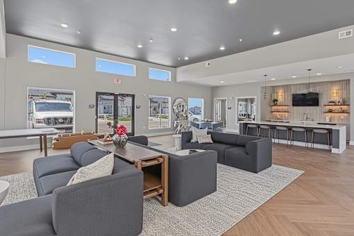 A modern living room with grey couches and a wooden coffee table.