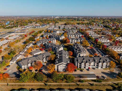 an aerial view of a neighborhood with houses and trees at 92West, Iowa, 50266