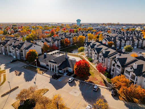an aerial view of a neighborhood with houses and trees at 92West, West Des Moines  