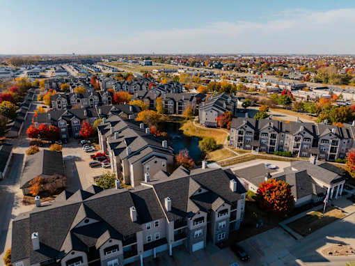 an aerial view of a neighborhood with houses and trees at 92West, West Des Moines  