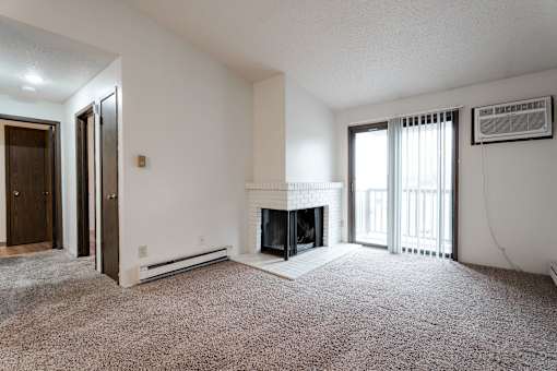 A living room with a fireplace and a carpet. at Bristol Ridge, Urbandale, IA