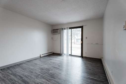 A room with a sliding glass door and a window. at Bristol Ridge, Urbandale