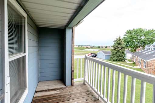 a balcony with a view of a yard and a house at Creekstone Falls, Sioux Falls, SD