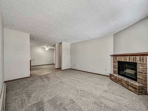 a living room with a fireplace and a carpeted floor at Creekstone Falls, South Dakota, 57106
