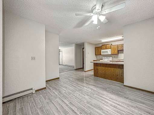 a view of a kitchen and living room with a geometric tile floor at Creekstone Falls, Sioux Falls, SD
