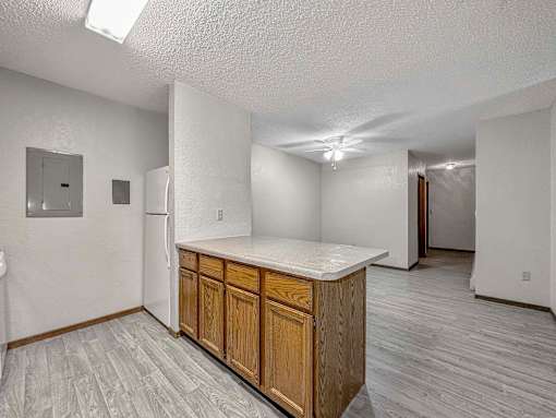 an empty kitchen with a counter top and a refrigerator at Creekstone Falls, Sioux Falls, SD, 57106