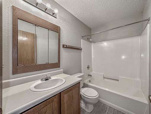 a bathroom with a sink and a toilet and a shower at Creekstone Falls, Sioux Falls, South Dakota