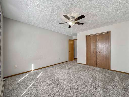 an empty living room with a ceiling fan at Creekstone Falls, Sioux Falls, SD, 57106
