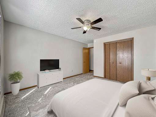 a bedroom with a bed and a ceiling fan at Creekstone Falls, Sioux Falls, SD