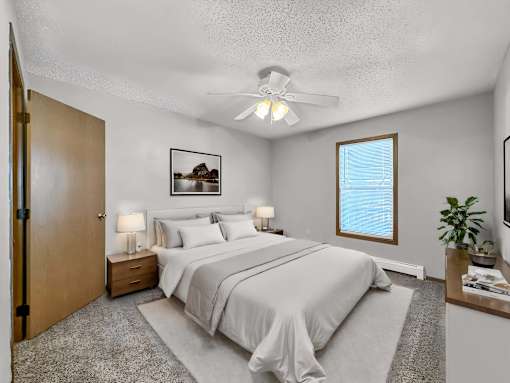 a bedroom with a bed and a ceiling fan at Creekstone Falls, Sioux Falls