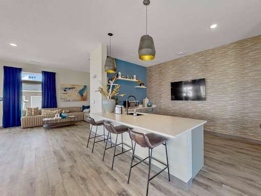 a kitchen with a white counter top and bar stools at Forge65, Pleasant Hill, 50327