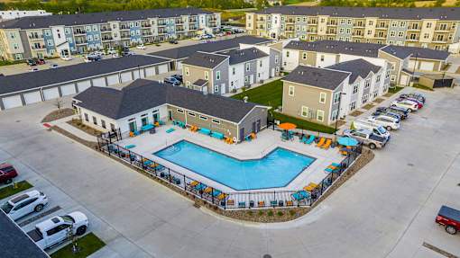 an aerial view of a swimming pool in an apartment complex  at Forge65, Pleasant Hill, IA, 50327