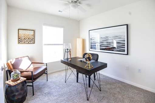 a dining room with a table and chairs and a ceiling fan at Forge65, Pleasant Hill, 50327