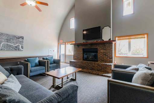 A living room with a fireplace and a television.