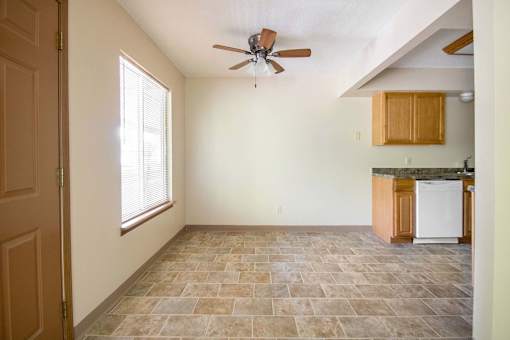 A room with a ceiling fan and a washing machine at Hunters Run Apartments, Newton, IA