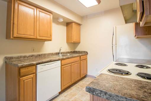 Kitchen with Brown cabinets at Hunters Run Apartments, Newton