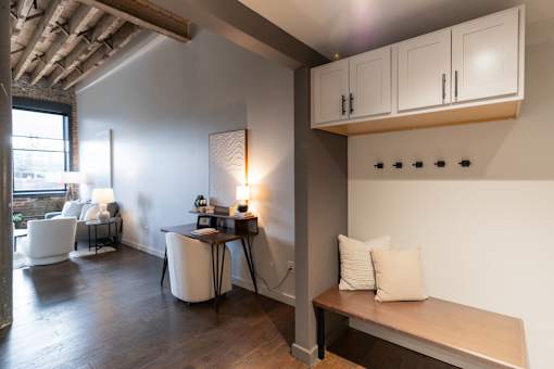 A room with a table, chairs, and a bench.at Plant 1 Lofts, N. Newton, IA 50208  