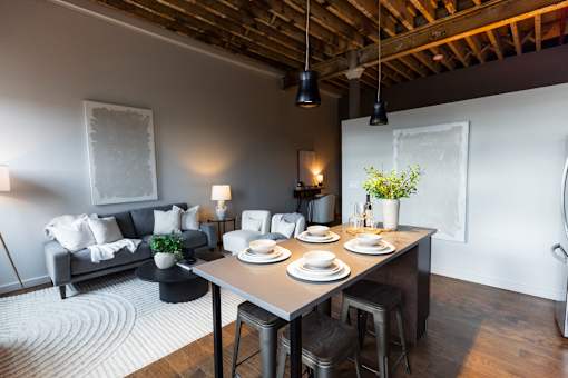 A dining area with a table set for two.at Plant 1 Lofts, N. Newton, IA 50208  