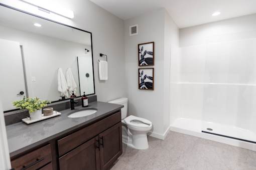 A bathroom with a white toilet and a white bathtub.at Plant 1 Lofts, N. Newton Iowa   