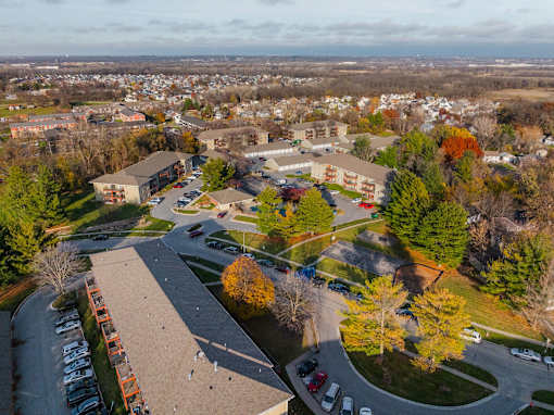 A view of a residential area with apartment buildings and trees. at Rosemont Place Apartments, Des Moines, Iowa