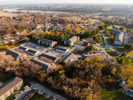 An aerial view of a residential area with houses and trees. at Rosemont Place Apartments, Des Moines, IA