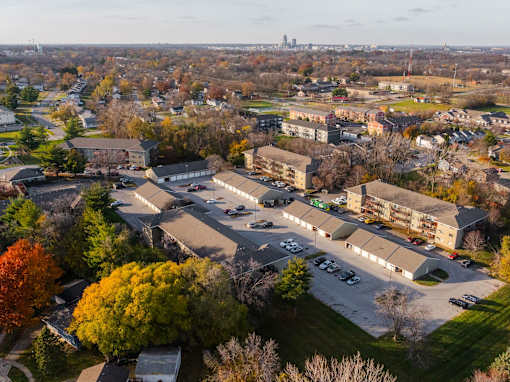 A large building complex with a parking lot in front of it at Rosemont Place Apartments, Des Moines, Iowa