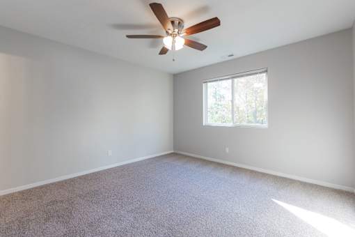 A room with a ceiling fan and a window. at Saylorville Lakeside, Polk City, IA, 50226
