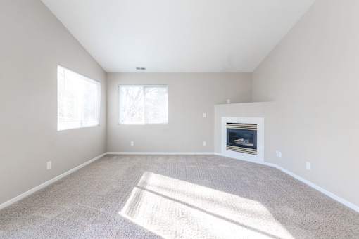 A sunny room with a fireplace and carpet. at Saylorville Lakeside, Iowa