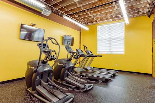 A row of treadmills are lined up in a gym at Spaulding Lofts Apartments, Grinnell, Iowa