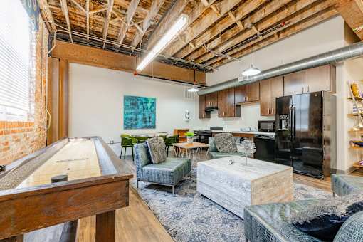 A room with a pool table and a couch at Spaulding Lofts Apartments, Grinnell
