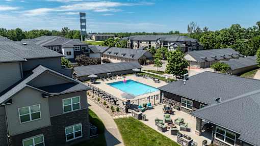 A large building complex with a pool in the middle.