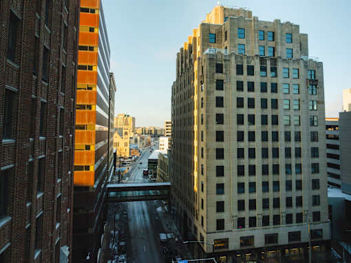 A city street with buildings on either side and a clear sky.
