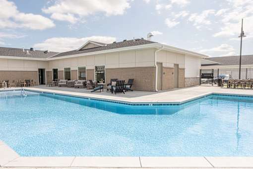 A large swimming pool in front of a building.