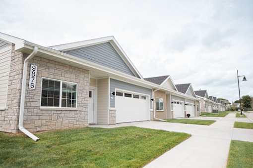 A row of houses with the number 9876 on the first one.