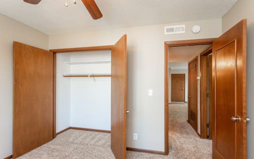 the view of a bedroom with a closet and a mirrored closet door at Lake Shore Place Apartments, Ankeny, IA,  50021