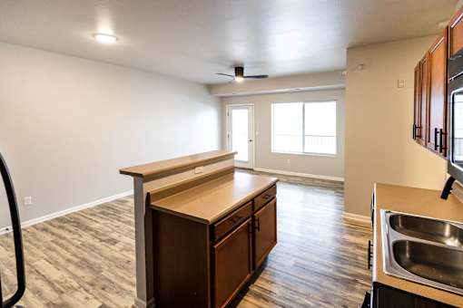 A kitchen with a sink, stove, and cabinets at Meadowlark Place Apartments, Georgia