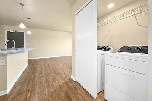 A laundry room with a washer and dryer at Melbourne Apartments in Des Moines, Iowa 50320.