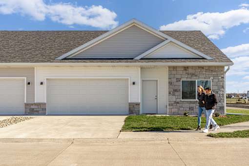 two people walking in front of a house at Converge NW, Waukee  