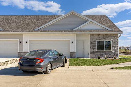 a car parked in front of a house at Converge NW, Waukee, IA  