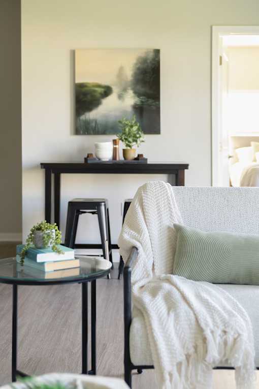 a living room with a couch and a bar with stools at Converge NW, Iowa  