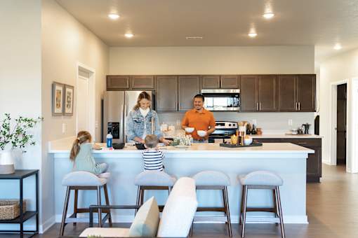 a family in the kitchen of a modern house at Converge NW, Waukee, IA  