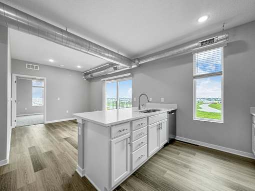 a white kitchen with a sink and a window at Converge NW, Waukee, IA 50263  