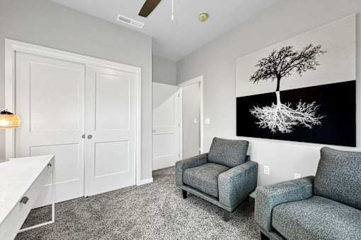 a living room with two chairs and a table at Converge NW, Waukee Iowa  
