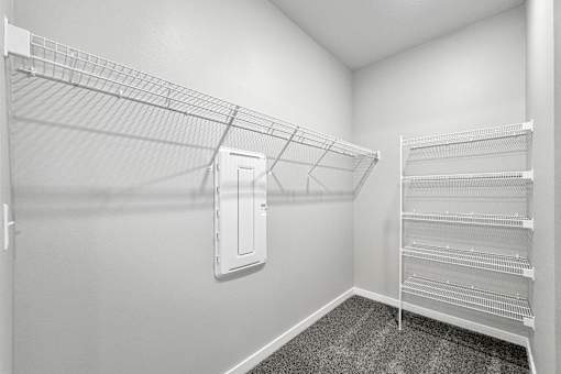 the spacious closet in the bedroom of a home with mirrored closets and a closet at Converge NW, Iowa  