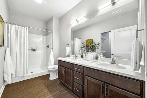 a bathroom with a sink and a shower and a toilet at Converge NW, Waukee Iowa  